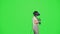 The little girl wearing VR headset dancing in virtual reality. The child dancing on chroma key green screen background