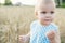 Little girl in wheat field. healthy child on picnic with bread and milk in golden cereal field