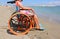 Little girl on the wheelchair on the beach