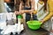 Little girl whipping flour in bowl using culinary whisk