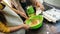 Little girl whipping with whisk while woman adding milk