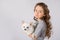 Little girl with white chihuahua dog on white background. Kids Pet Friendship