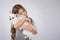 Little girl with white dog isolated on gray background. Kids Pet Friendship
