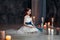 Little girl in white dress in room with candles kids pray