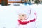 Little girl in white stands on playground