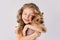 Little girl with white Yorkshire Terrier dog on white background. Kids Pet Friendship