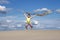 Little girl on windy beach