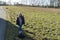 Little girl in winter clothes standing in the middle of a meadow