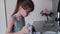 little girl wiping dishes after washing, child\'s homework, helping mom
