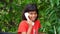 Little girl and wireless phone. Little Indian girl seeing next to a vintage white telephone