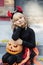 little girl in witch costume celebrate Halloween outdoor and have fun