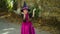 Little girl in a witch costume witch funny dances on the street..