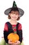 Little girl witch with pumpkin halloween