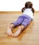 A little girl on a wooden floor