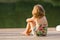 Little girl on wooden jetty