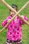 Little girl with wooden stick pole doing cross in fun fight