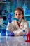 Little girl working in science chemical in the class of the laboratory of school