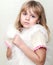 Little girl wraps up in white fluffy fur vest