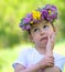 Little girl with a wreath of flowers on her head