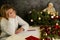 Little girl writes a letter to Santa Claus. Emotions: joy, happiness, thoughtfulness, fatigue ... Christmas should be hurried soon