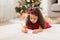 Little girl writing christmas wish list at home