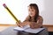Little girl writing with a giant pencil