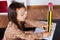 Little girl writing with a giant pencil