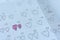 Little girl written heart thumbtack in date of February 14 Valentine.