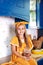 Little girl in a yellow dress holds a jar of raw pasta on the background of the kitchen at home. Little cook. Healthy eating conce