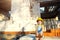 Little girl in a yellow hardhat is playing builder on the construction site of her future home. Expectation of moving, choosing a