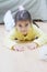 Little girl in yellow laying on floor
