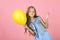 Little girl with yellow rubber balloon