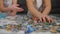 Little girls assemble puzzle details, hands close up