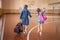 Little girls with backpacks in an empty school gym