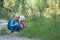 Little girls collecting flowers in summer, kids learn nature