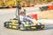 Little girls are driving Go- Kart car in a playground racing track