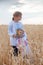 Little girls  in   embroidered shirt on   wheat field