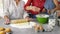 Little girls, grandma and his mom preparing cake