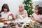 Little girls having fun while making christmas Nativity crafts with their grandmother