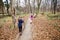 Little girls hiking through autumn forest