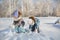 Little girls play with snow in a park in winter