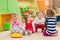 Little girls playing with toys in playroom