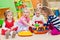 Little girls playing with toys in playroom