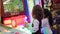 Little girls playing video arcade game in game center