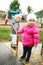 Little Girls Playing on a Vintage Merry-go-Round Outside on the