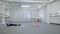 Little girls practice with teacher in ballet studio.