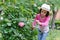 Little girls pruning roses