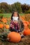 Little girls in pumpkin patch