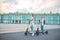 Little girls riding an electric scooter on Palace Square in St. Petersburg.