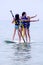 Little girls show off on paddle board